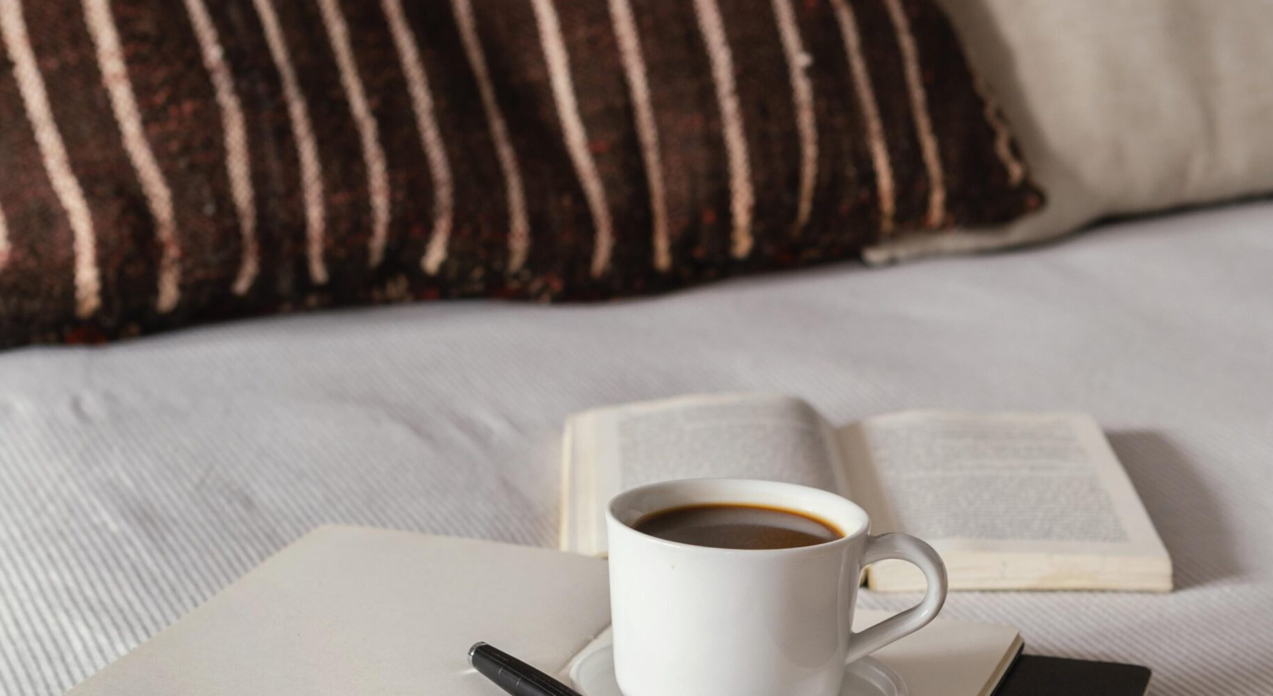 high-angle-coffee-books-bed